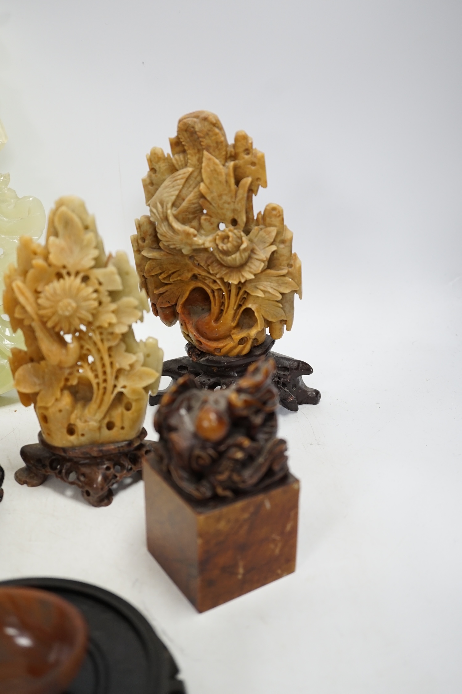 A group of nine Chinese hardstone and soapstone figures, tallest 26cm. Condition - fair